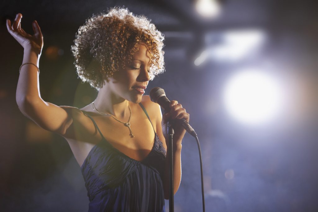 Beautiful African American female jazz singer on stage